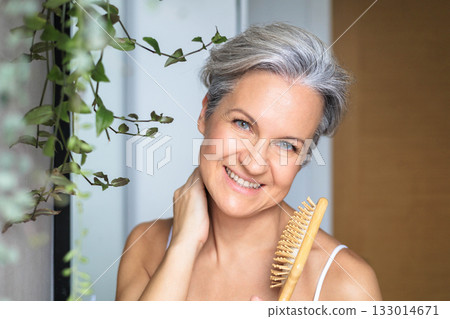 Portrait of a beautiful, smiling middle-aged European woman with gray hair in the bathroom 133014671