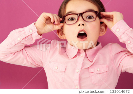 Portrait, shocked and girl child with glasses in studio isolated on a pink background. Kid, nerd and face of surprised person, wow or omg, emoji or reaction to unexpected news, announcement or secret 133014672