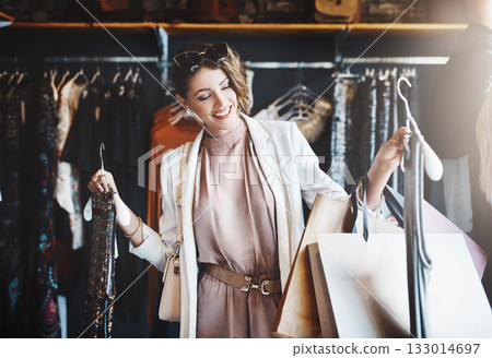 Stylist, rich or happy woman shopping in boutique store looking at clothes or choosing her favorite style. Choice, decision or female designer with trendy apparel picking an outfit or classy fashion Stylist, rich or happy woman shopping in boutique store looking at clothes or choosing her favorite style. Choice, decision or female designer with trendy apparel picking an outfit or classy fashion 133014697