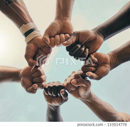 Hands, fist and unity with a sports team standing in a huddle for solidarity or motivation before a game. Fitness, teamwork and diversity with a group of men in a circle, getting ready for a match 133014776