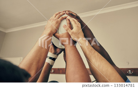Locker room, hands together and rugby team huddle with with ball, motivation and teamwork before game. Training, coaching and group of motivated sports players with commitment, dedication and support Locker room, hands together and rugby team huddle with with ball, motivation and teamwork before game. Training, coaching and group of motivated sports players with commitment, dedication and support 133014781