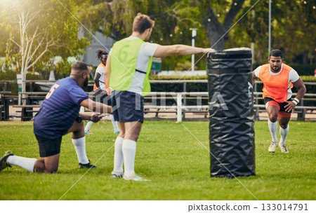 Rugby, teamwork and men training on field with equipment ready for match, practice and sports game. Fitness, performance and male athletes running for warm up, exercise and workout for competition Rugby, teamwork and men training on field with equipment ready for match, practice and sports game. Fitness, performance and male athletes running for warm up, exercise and workout for competition 133014791