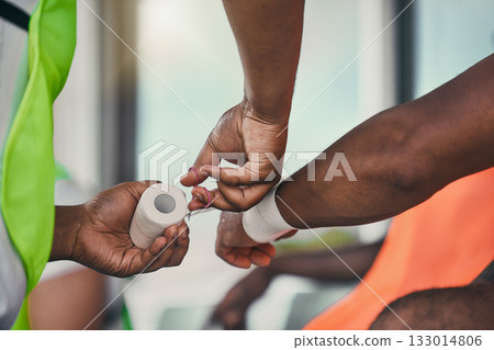 Bandage, wrist injury and man with medic after practice match, training and sports game in stadium. Medical emergency, health worker and hands of athlete with joint sprain, accident and tendinitis Bandage, wrist injury and man with medic after practice match, training and sports game in stadium. Medical emergency, health worker and hands of athlete with joint sprain, accident and tendinitis 133014806