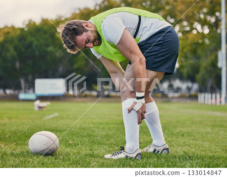 Rugby, pain and man with legs injury on sports field after practice match, training and game outdoors. Medical emergency, accident and male athlete with joint inflammation, knee sprain and tendinitis Rugby, pain and man with legs injury on sports field after practice match, training and game outdoors. Medical emergency, accident and male athlete with joint inflammation, knee sprain and tendinitis 133014847