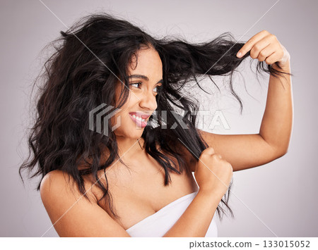 Woman, messy hair and disgust for entangled problem holding split ends against white studio background. Frustrated or confused female model in haircare touching curly mess, damaged or tangled hairdo 133015052