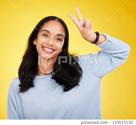 Happy, woman and portrait of peace fingers in studio, background and color backdrop. Female model, v sign and smile with hands for victory, fun mood and happiness of gen z, victory and freedom emoji Happy, woman and portrait of peace fingers in studio, background and color backdrop. Female model, v sign and smile with hands for victory, fun mood and happiness of gen z, victory and freedom emoji 133015130