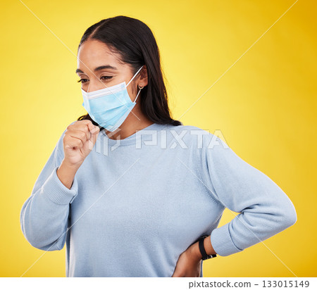 Covid, cough and sick with woman in studio for medical, virus and breathing problems. Illness, pandemic and healthcare with female and face mask on yellow background for disease, infection and flu 133015149