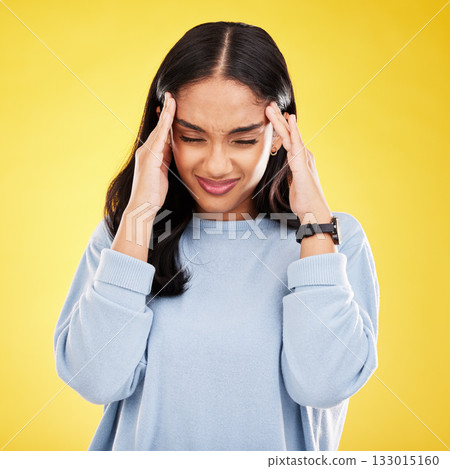 Young woman, stress and burnout with headache, pain and distress isolated on yellow studio background. Female massage temple, mental health and anxiety with depression, frustrated and trauma migraine Young woman, stress and burnout with headache, pain and distress isolated on yellow studio background. Female massage temple, mental health and anxiety with depression, frustrated and trauma migraine 133015160