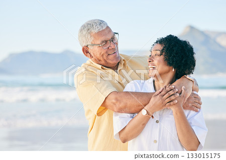 Senior couple at beach, hug and happy with travel, retirement and love outdoor, vacation with view and relax in nature. Peace, zen and tropical island, man and woman with marriage and happiness 133015175