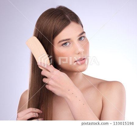 Portrait, beauty and woman brushing hair in studio for for shiny, healthy and growth results on grey background. Face, haircare and brush by girl model relax with luxury comb for smooth care or shine Portrait, beauty and woman brushing hair in studio for for shiny, healthy and growth results on grey background. Face, haircare and brush by girl model relax with luxury comb for smooth care or shine 133015198
