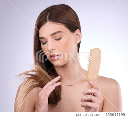 Split ends, hair and woman holding a brush in a isolated, white background and studio. Beauty salon, dye treatment damage and cosmetics of a young female model upset about haircut growth problem Split ends, hair and woman holding a brush in a isolated, white background and studio. Beauty salon, dye treatment damage and cosmetics of a young female model upset about haircut growth problem 133015199