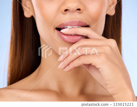 Skincare, mouth and woman biting finger in studio zoom isolated on blue background for lip care. Natural beauty, luxury cosmetics and bite on hand, face closeup of hispanic model with makeup on lips. Skincare, mouth and woman biting finger in studio zoom isolated on blue background for lip care. Natural beauty, luxury cosmetics and bite on hand, face closeup of hispanic model with makeup on lips. 133015221