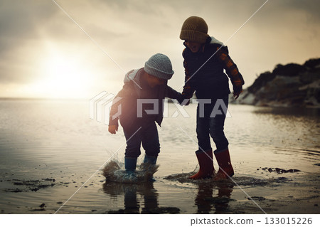 Sunset, silhouette and friends on beach, playing and bonding on summer vacation, break and happiness. Dusk, young people and kids on seaside holiday, brothers and ocean with children, joy or cheerful Sunset, silhouette and friends on beach, playing and bonding on summer vacation, break and happiness. Dusk, young people and kids on seaside holiday, brothers and ocean with children, joy or cheerful 133015226