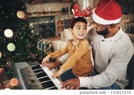 Happy family, father and kid at piano for christmas celebration, song and xmas at home. Parent, boy child and teaching keyboard instrument, festive music or celebrate holiday spirit together in house 133015278