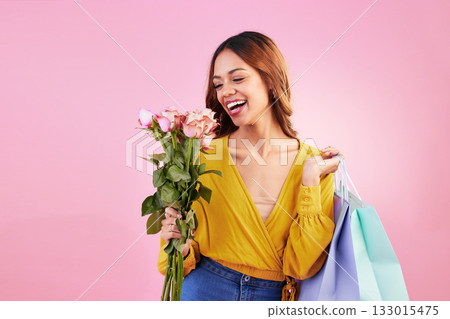 Happy, shopping bags and smile with woman and flowers in studio for retail, birthday and spring. Event, party and celebration with female and roses on pink background for sale, discount and romance Happy, shopping bags and smile with woman and flowers in studio for retail, birthday and spring. Event, party and celebration with female and roses on pink background for sale, discount and romance 133015475