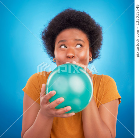 Balloon, happy and black woman in studio for celebration, good news or birthday on blue background. Party, blowing and girl with inflatable while celebrating, excited and having fun while isolated 133015549