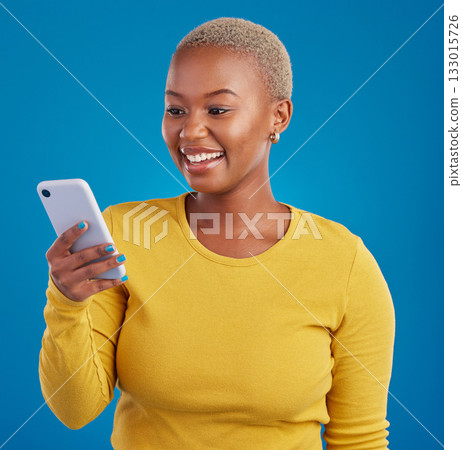 Phone, happy and black woman typing in studio for social media, text message and browse website. Communication mockup, technology and girl on internet, networking and chat online on blue background Phone, happy and black woman typing in studio for social media, text message and browse website. Communication mockup, technology and girl on internet, networking and chat online on blue background 133015726