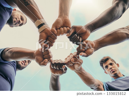 Hands, fist and solidarity with a sports team standing in a huddle for unity or motivation before a game. Fitness, teamwork and diversity with a group of men in a circle, getting ready for a match Hands, fist and solidarity with a sports team standing in a huddle for unity or motivation before a game. Fitness, teamwork and diversity with a group of men in a circle, getting ready for a match 133015812