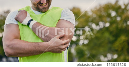 Rugby, pain and man with arm injury on sports field after practice match, training and game outdoors. Medical emergency, accident and male athlete with joint inflammation, elbow sprain and tendinitis Rugby, pain and man with arm injury on sports field after practice match, training and game outdoors. Medical emergency, accident and male athlete with joint inflammation, elbow sprain and tendinitis 133015828