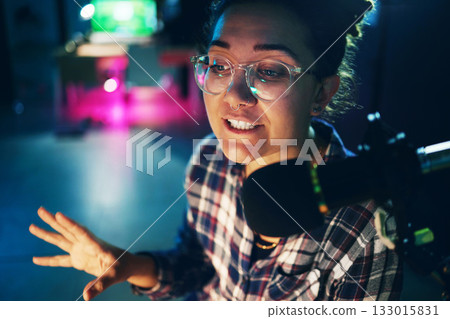 Podcast, microphone and young woman speaking, advice or broadcast on gen z platform, live streaming and night neon. Influencer person voice talking on mic for news, politics or media report or radio 133015831
