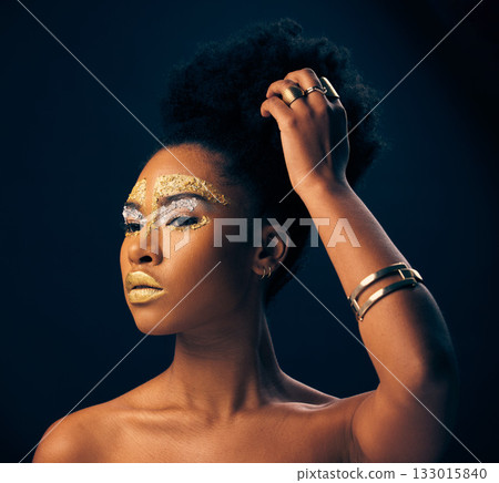 Beauty, gold and glitter with black woman and makeup in studio for luxury, cosmetics or African pride. Natural, creative and goddess with female model on black background for queen, bronze or glamour Beauty, gold and glitter with black woman and makeup in studio for luxury, cosmetics or African pride. Natural, creative and goddess with female model on black background for queen, bronze or glamour 133015840