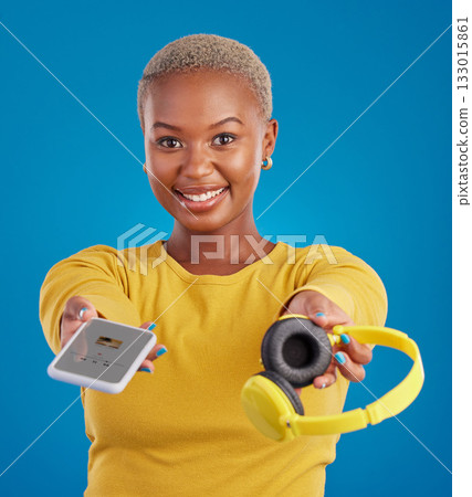Music, sharing and phone with portrait of black woman in studio for streaming, giving and multimedia for you. Podcast, mobile radio and technology with female on blue background for headphones audio Music, sharing and phone with portrait of black woman in studio for streaming, giving and multimedia for you. Podcast, mobile radio and technology with female on blue background for headphones audio 133015861