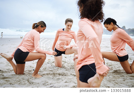 Volleyball, stretching legs and women on beach ready to play match, competition and sports game. Teamwork, fitness and female players stretch body for warm up practice, training and exercise on sand Volleyball, stretching legs and women on beach ready to play match, competition and sports game. Teamwork, fitness and female players stretch body for warm up practice, training and exercise on sand 133015888