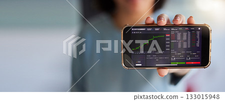 Stock market chart, screen and phone in hands of woman for crypto, trading analysis and bitcoin mockup. Fintech growth, ecommerce and girl on smartphone for financial statistics, profit app or invest Stock market chart, screen and phone in hands of woman for crypto, trading analysis and bitcoin mockup. Fintech growth, ecommerce and girl on smartphone for financial statistics, profit app or invest 133015948