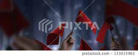 USSR flags in their hands on a blurred urban background 133015963