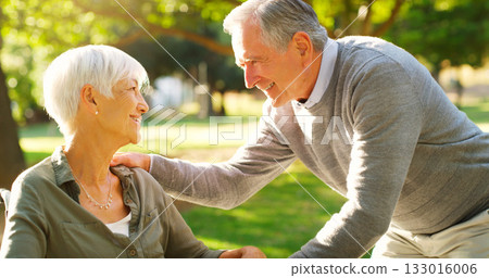 Senior couple, happy and talking outdoor at a park with love, care and support. A elderly man and woman in nature for communication, quality time and healthy marriage or retirement with understanding 133016006