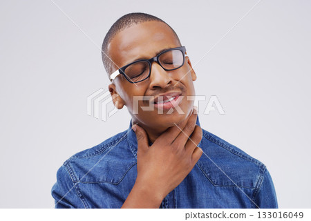 Black man, sore throat and virus from cough, allergies or bacteria against a white studio background. Sick African male person touching neck in pain, allergy or flu of cold, illness or infection 133016049