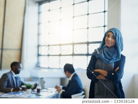 Business woman, muslim and arms crossed portrait in an office with a smile for career pride. Arab female entrepreneur or leader at a diversity and corporate workplace with a positive mindset 133016126