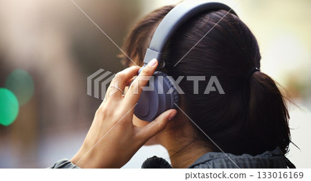 Woman with headphones in city, back view and listen to music, freedom and technology outdoor. Mockup space, podcast or radio streaming with female person in urban street and audio playlist 133016169