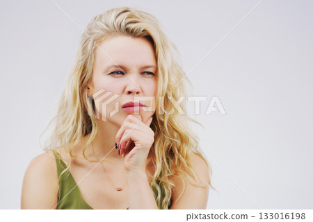 Young woman, thinking and confused in studio with ideas, memory and focus by gray background. Girl, model and think with concentration, remember and decision for choice, planning or question on mind 133016198