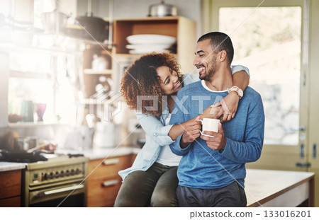 Love, coffee and happy couple in kitchen, morning hug in home with smile, hugging and healthy relationship. Happiness, man and woman embrace with affection, romance and young people in apartment. Love, coffee and happy couple in kitchen, morning hug in home with smile, hugging and healthy relationship. Happiness, man and woman embrace with affection, romance and young people in apartment. 133016201