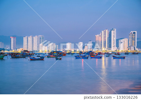 Traditional Vietnamese fishing boats at sea in Nha Trang city in Vietnam at sunrise in the morning 133016226