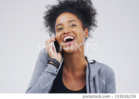 Phone call, funny and black woman speaking in studio isolated on a white background with mockup. Cellphone, laughing and African female person in communication, happy conversation and comic comedy. 133016239