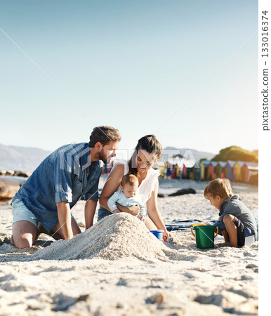Sandcastle, holiday and children at the beach with family, love and support. Baby, mom and dad together with kids playing in the sun with happiness and smile by the ocean and mockup with bonding 133016374