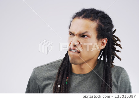 Man, funny face and goofy expression on mockup space against a white studio background. Young male person or model with silly faces and braids for comedy, comic or crazy mood and strange attitude 133016397