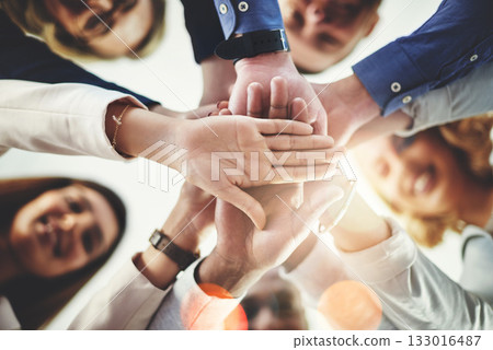 Team, hands of colleagues together and smile with huddle for collaboration for goal with lens flare. Teamwork or cooperation, businesspeople or coworkers and happy people with hand for support Team, hands of colleagues together and smile with huddle for collaboration for goal with lens flare. Teamwork or cooperation, businesspeople or coworkers and happy people with hand for support 133016487