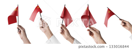 The USSR flag in hand in different angles on a white background 133016844