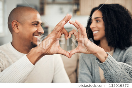 Love, happy and hand heart by couple on sofa with love, care and trust at home together. Emoji, shape and man with woman hands in support of hope, marriage and unity, smile and joy in living room Love, happy and hand heart by couple on sofa with love, care and trust at home together. Emoji, shape and man with woman hands in support of hope, marriage and unity, smile and joy in living room 133016872