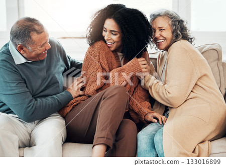 Family, playful and a black woman at her parents home for a visit while bonding on a sofa in the living room together. Love, relax and a senior father tickling his daughter while having fun Family, playful and a black woman at her parents home for a visit while bonding on a sofa in the living room together. Love, relax and a senior father tickling his daughter while having fun 133016899