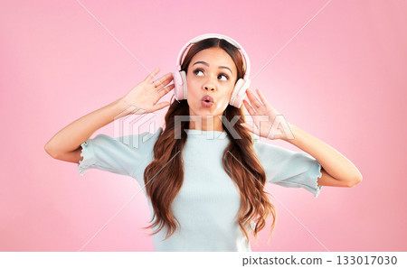 Music headphones, singing and woman whistle in studio isolated on a pink background. Singer, thinking and mixed race female streaming, enjoying and listening to audio, sound track or radio podcast. Music headphones, singing and woman whistle in studio isolated on a pink background. Singer, thinking and mixed race female streaming, enjoying and listening to audio, sound track or radio podcast. 133017030