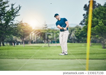 Golf, stroke and aim with a sports man swinging a club on a field or course for recreation, fun and hobby. Golfing, grass and training with a male golfer playing a game on a green during summer Golf, stroke and aim with a sports man swinging a club on a field or course for recreation, fun and hobby. Golfing, grass and training with a male golfer playing a game on a green during summer 133017130