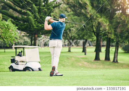 Golf, stroke and focus with a sports man swinging a club on a field or course for recreation and fun. Golfing, grass and training with a male golfer playing a game on a green during summer Golf, stroke and focus with a sports man swinging a club on a field or course for recreation and fun. Golfing, grass and training with a male golfer playing a game on a green during summer 133017191