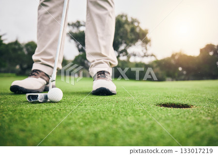 Golf, hole and player hit ball and professional athlete training and putting on a filed as exercise or workout. Sportsman, equipment and gentleman golfer or person relax and playing a sport Golf, hole and player hit ball and professional athlete training and putting on a filed as exercise or workout. Sportsman, equipment and gentleman golfer or person relax and playing a sport 133017219