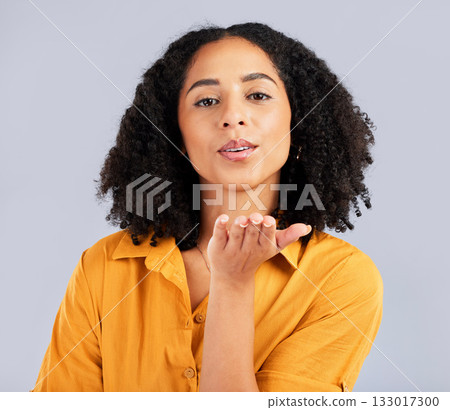 Flirty, happy and a portrait of a woman blowing kiss isolated on a studio background. Love, smile and a flirtatious girl with a loving, cute and romantic gesture on a backdrop for expression 133017300