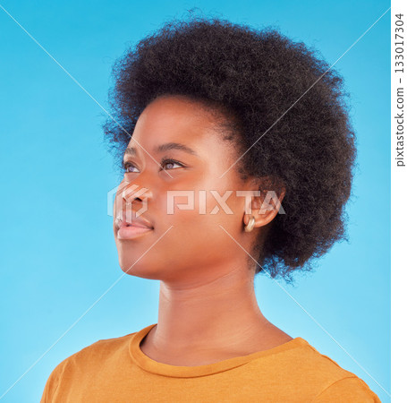 Thinking, idea and black woman wondering looking away in thought isolated against a blue studio background. Afro, casual and face of young African American female relax, calm and confident Thinking, idea and black woman wondering looking away in thought isolated against a blue studio background. Afro, casual and face of young African American female relax, calm and confident 133017304