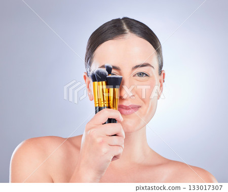 Makeup, cosmetic and portrait of a woman with brushes isolated on a studio background. Happy, beauty and model showing a brush set for cosmetics, foundation application and glamour on a backdrop Makeup, cosmetic and portrait of a woman with brushes isolated on a studio background. Happy, beauty and model showing a brush set for cosmetics, foundation application and glamour on a backdrop 133017307